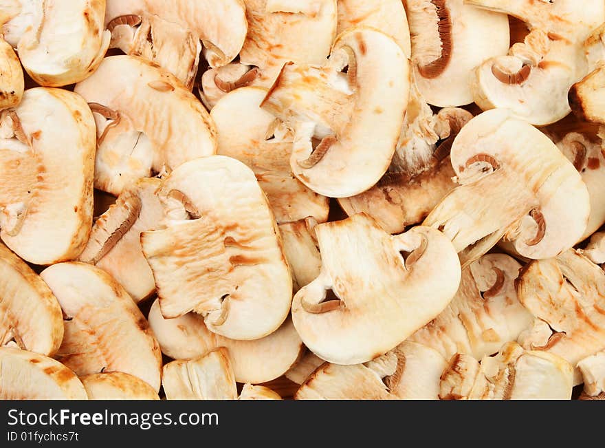 Sliced button mushrooms as a background and texture. Sliced button mushrooms as a background and texture