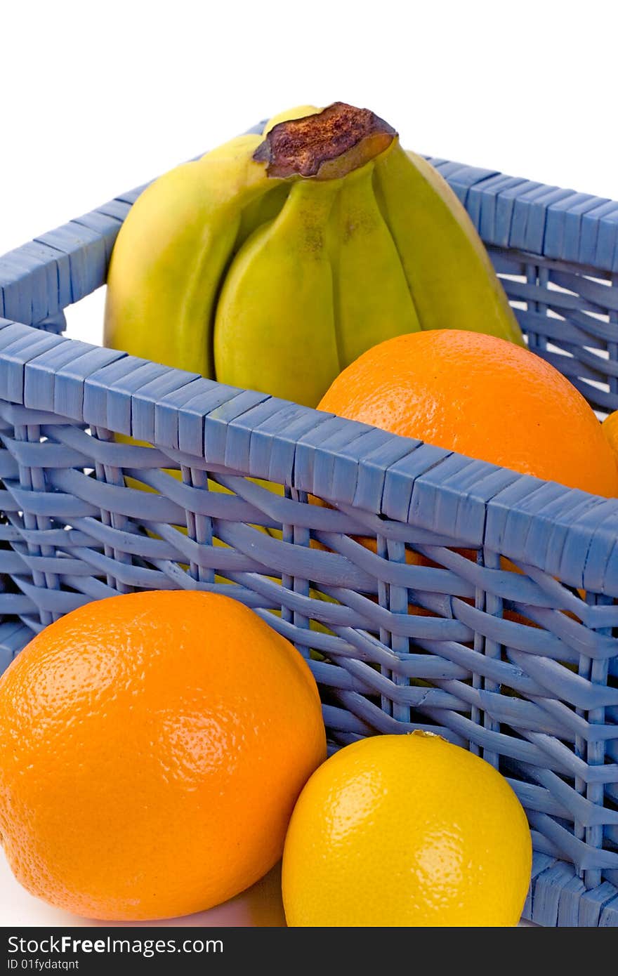 Blue basket with fruits on white background