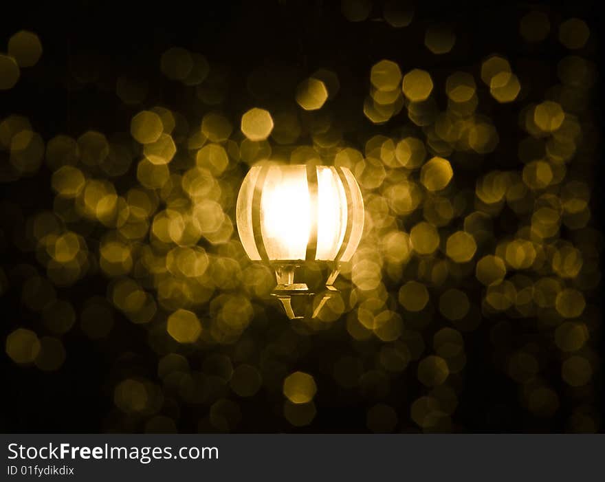 A street lamp at night through the wet window