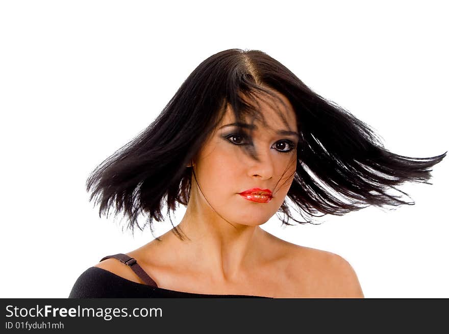 Portrait of woman with fluttered hair against white background