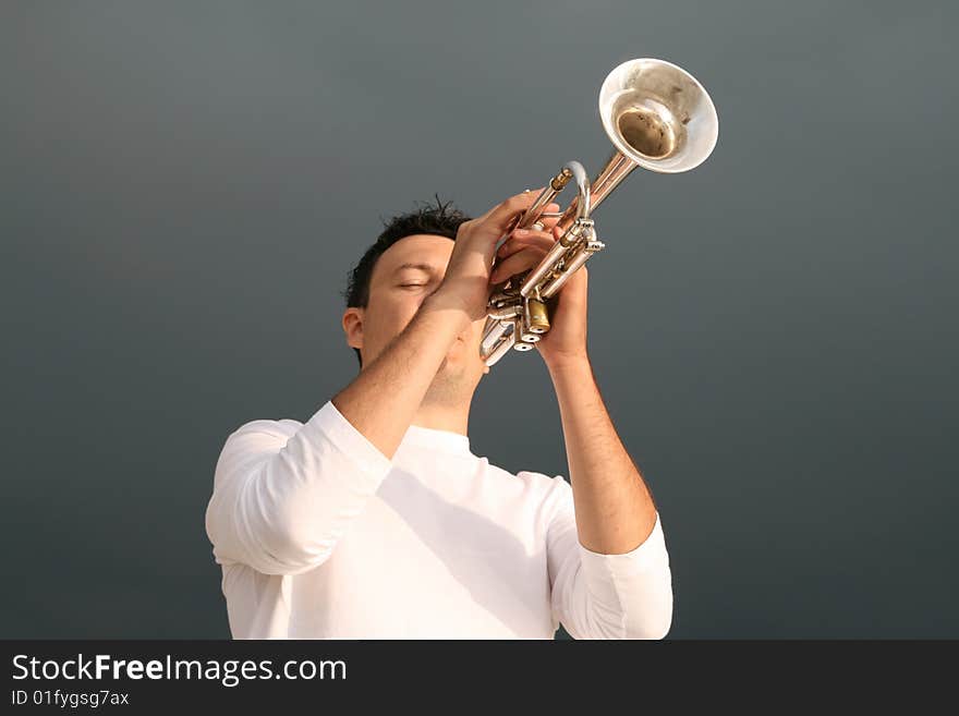 A man playing trumpet outdoor