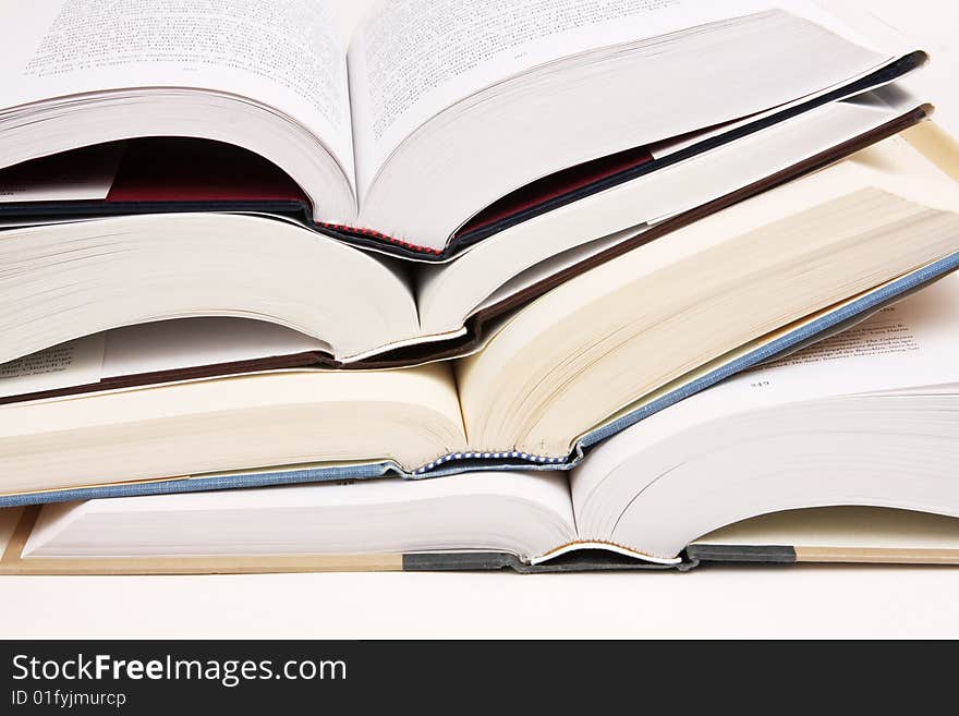 Stack of opened text books on a white background. Stack of opened text books on a white background.