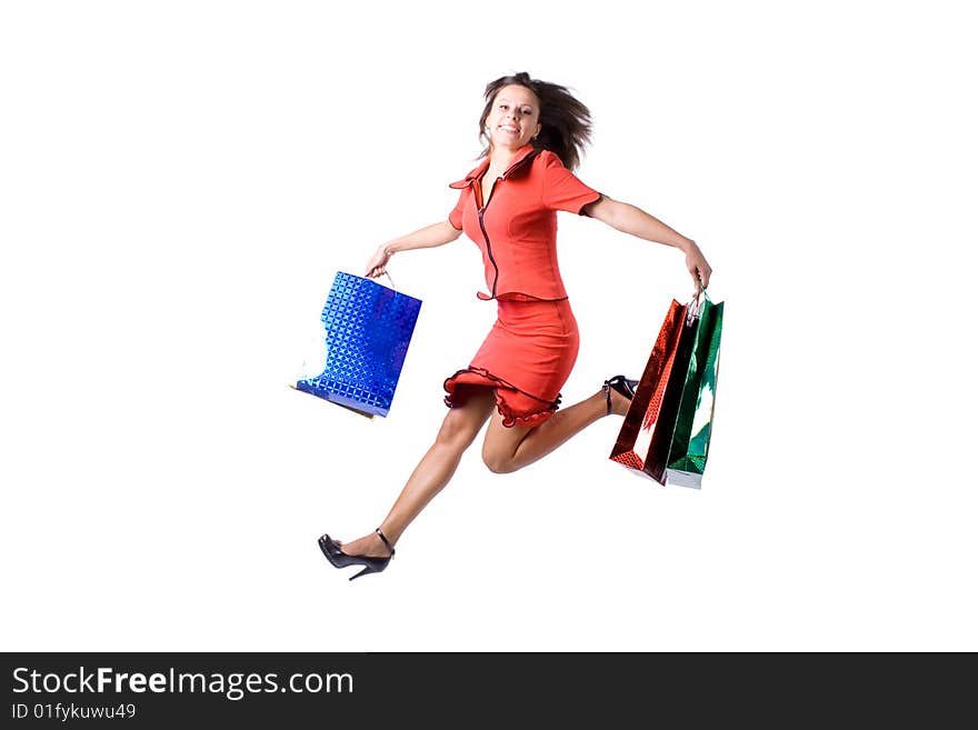 The young beautiful girl with purchases in colour packages during shopping on a white background. The young beautiful girl with purchases in colour packages during shopping on a white background