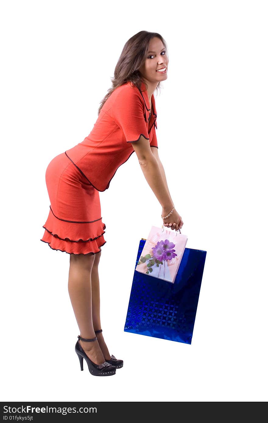 The young beautiful girl with purchases in colour packages during shopping on a white background. The young beautiful girl with purchases in colour packages during shopping on a white background