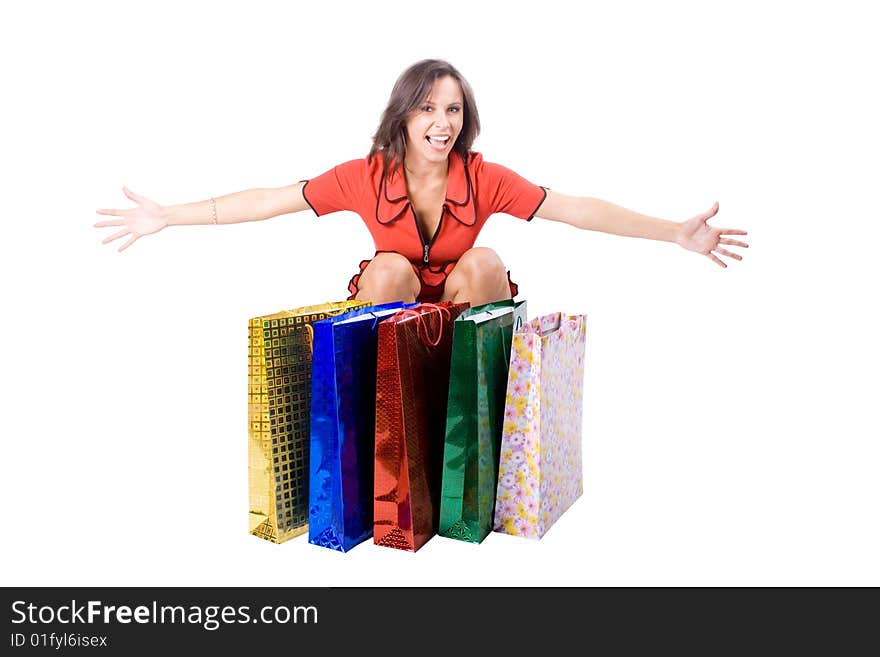 The young beautiful girl with purchases in colour packages during shopping on a white background. The young beautiful girl with purchases in colour packages during shopping on a white background