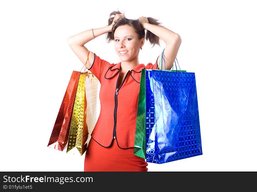 The young beautiful girl with purchases in colour packages during shopping on a white background. The young beautiful girl with purchases in colour packages during shopping on a white background