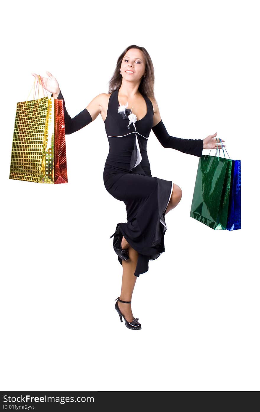 The young beautiful girl with purchases in colour packages during shopping on a white background. The young beautiful girl with purchases in colour packages during shopping on a white background