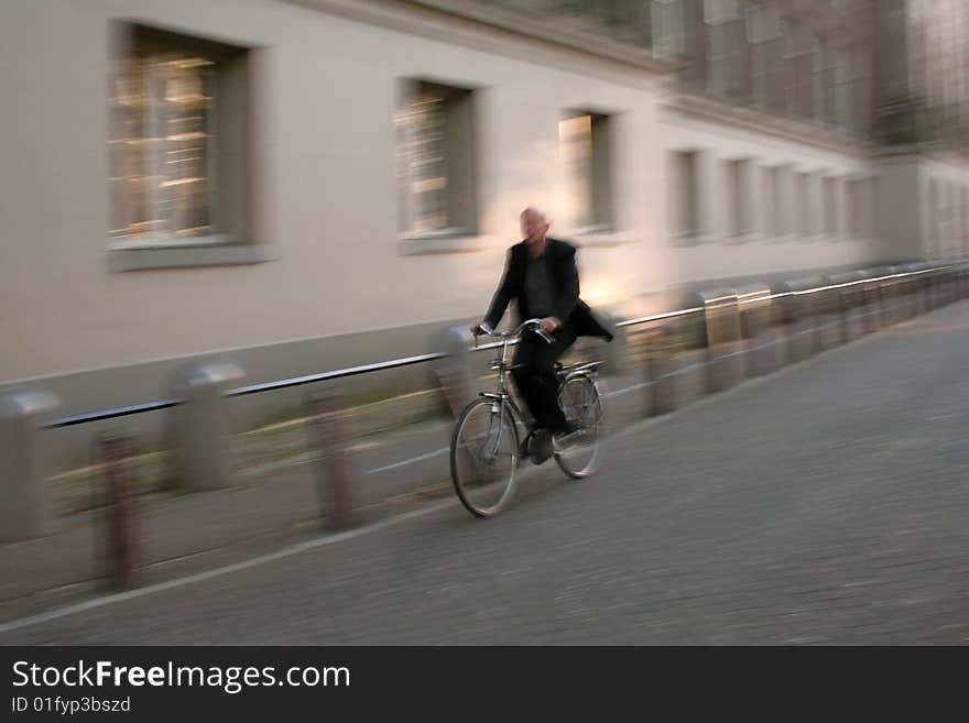 Man with halo riding his bike on the streets of Amsterdam . Man with halo riding his bike on the streets of Amsterdam