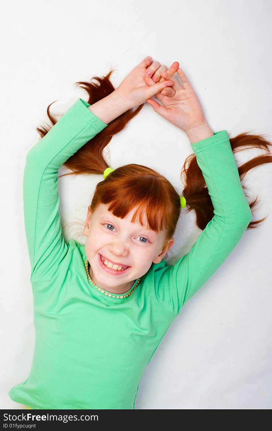 A red girl smiles. Photo on a white background. A red girl smiles. Photo on a white background.