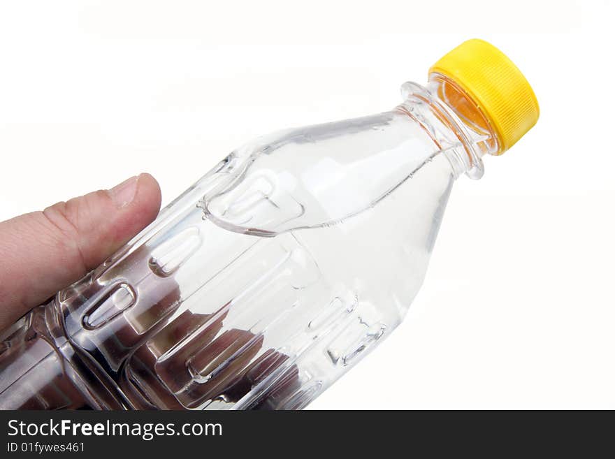 Holding a bottle of water on white.