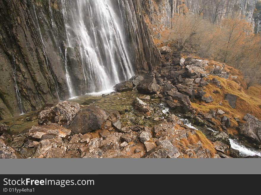 The beautiful waterfall in the forest, autumn (long exposure)