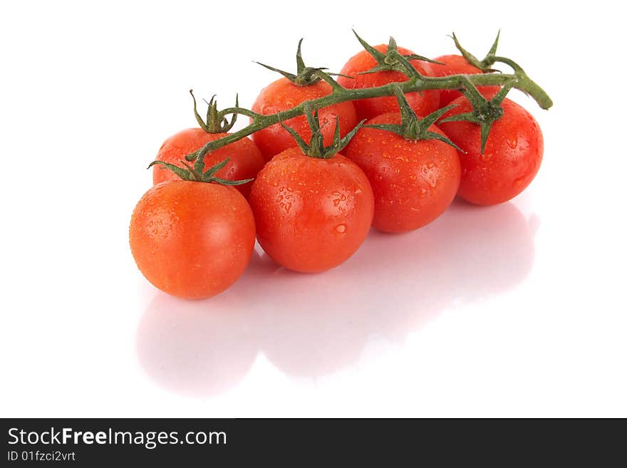 Macroshot of a bunch of tomatoes with dropd of water. Isolated over white background. Lot of copyspace. Macroshot of a bunch of tomatoes with dropd of water. Isolated over white background. Lot of copyspace.