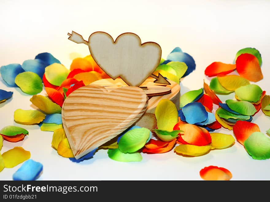 Wood heart box with colored flower petals. Wood heart box with colored flower petals