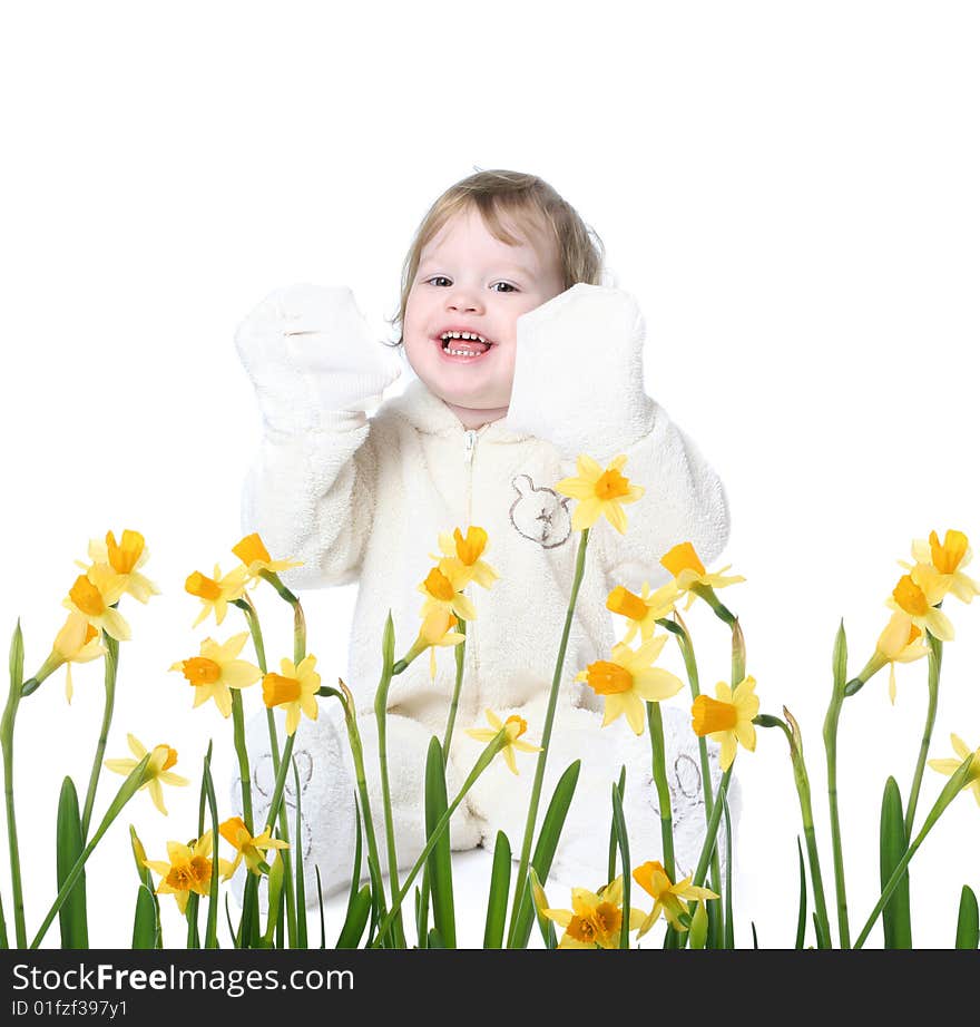 Funny little girl dressed in bear costume with yellow narcissus. Funny little girl dressed in bear costume with yellow narcissus