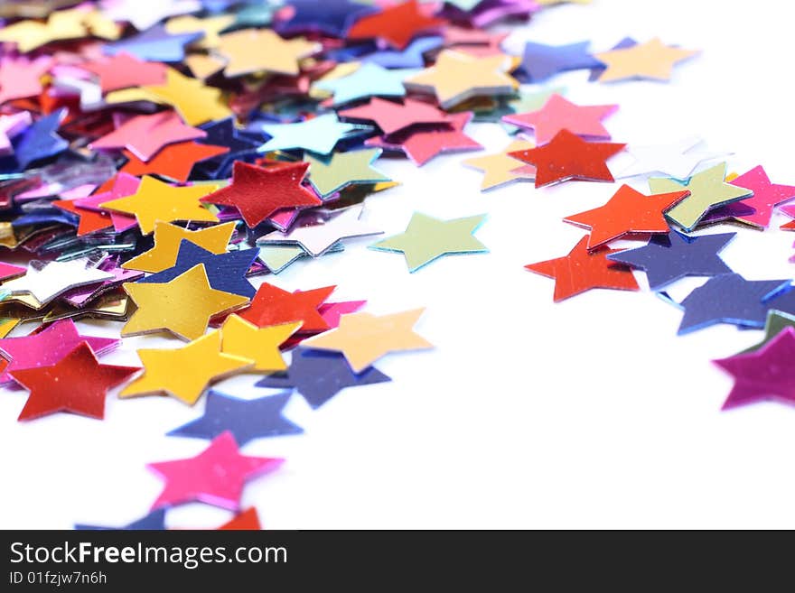 Stars in the form of confetti on white