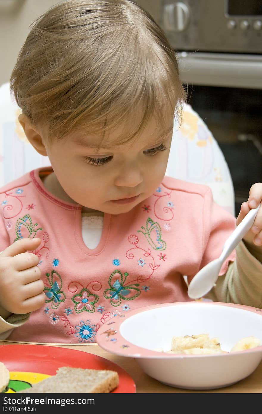 Sweet young baby girl eating. Sweet young baby girl eating