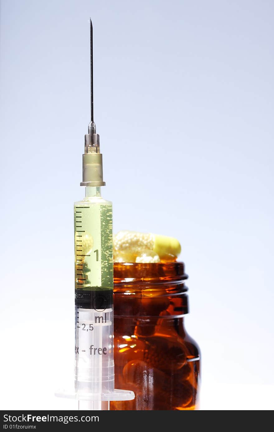 A Capsule bottle and syringe. A Capsule bottle and syringe