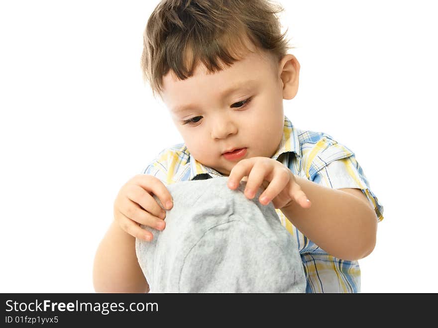 Portrait of a cute one year old boy putting on a hat