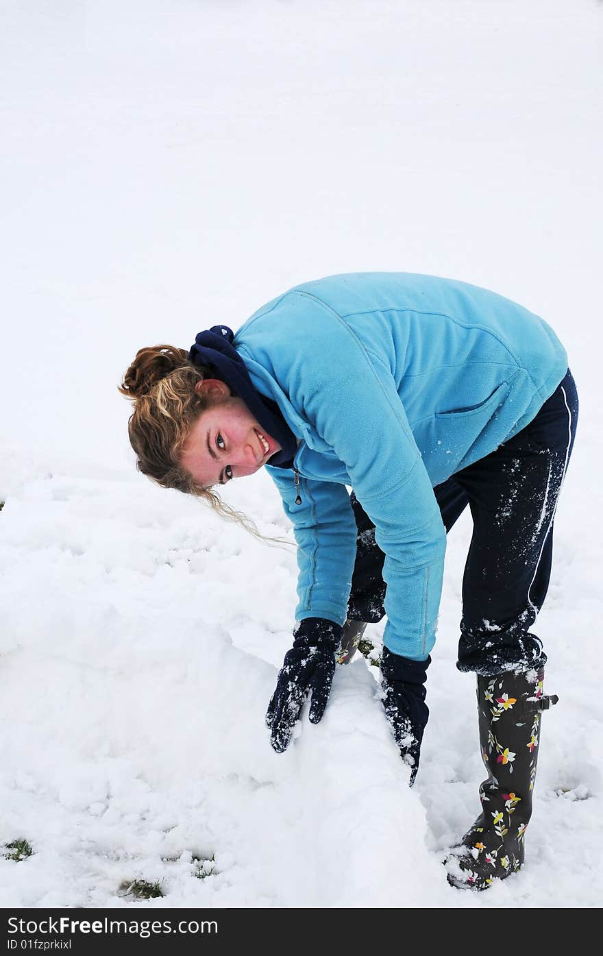 Teenage girl playing in snow