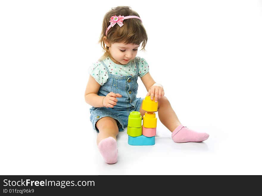 Cute one year old girl making a pyramid