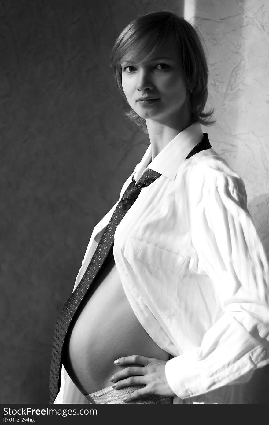 Pregnant woman in shirt and necktie. Pregnant woman in shirt and necktie