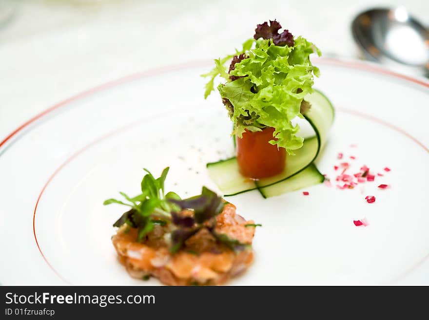 A appetizer meal is served with green vegetable. A appetizer meal is served with green vegetable