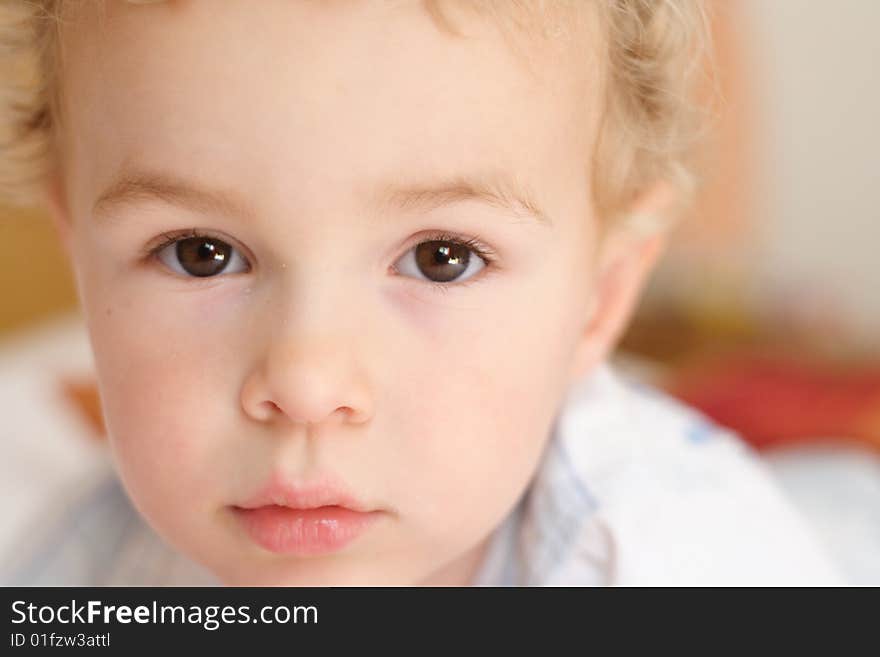 Kid staring at the camera with interogative expression. Kid staring at the camera with interogative expression