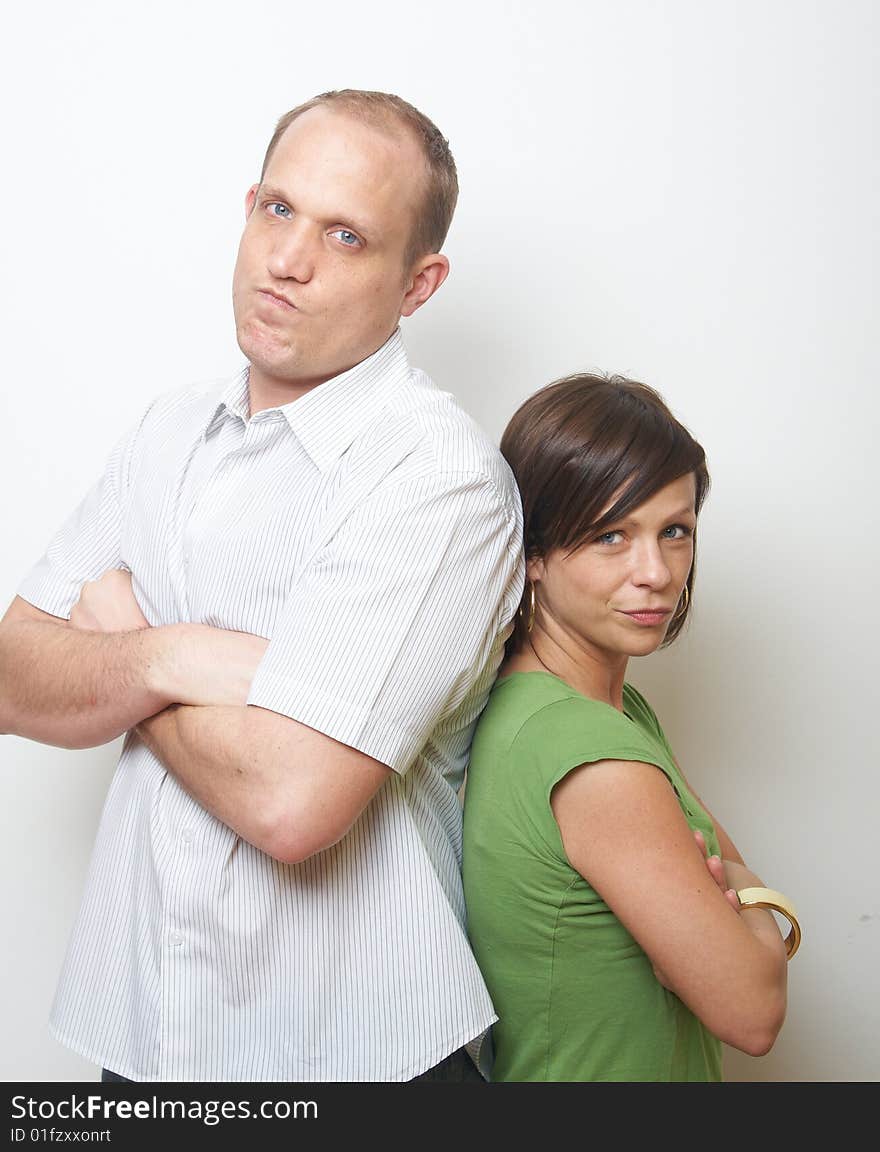 Young couple looking serious. They both wear casual clothes. Young couple looking serious. They both wear casual clothes.