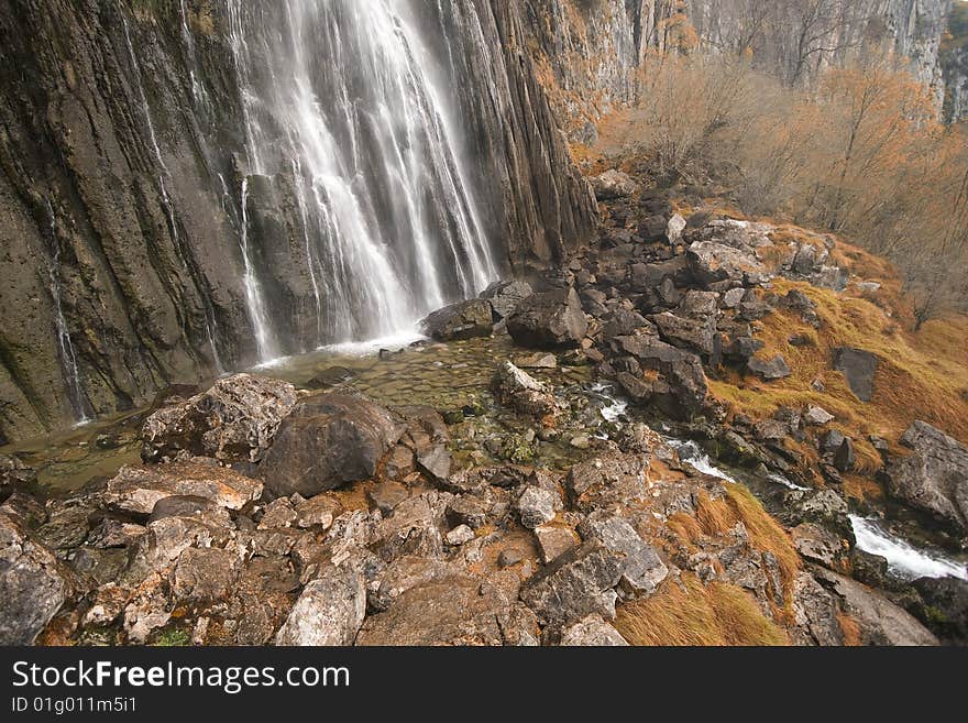 The beautiful waterfall in the forest, autumn (long exposure)