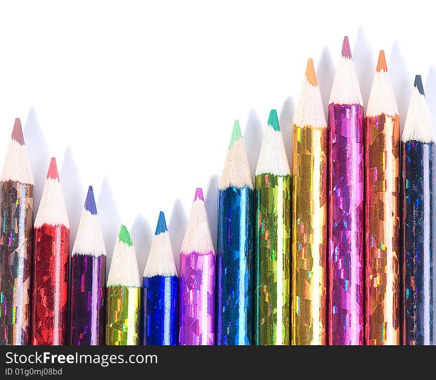 Assortment of coloured pencils with shadow on white background