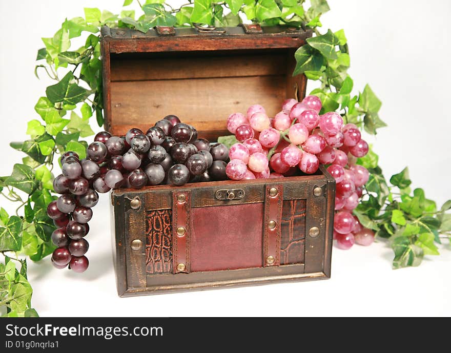 An array of grapes layed in a small chest. An array of grapes layed in a small chest