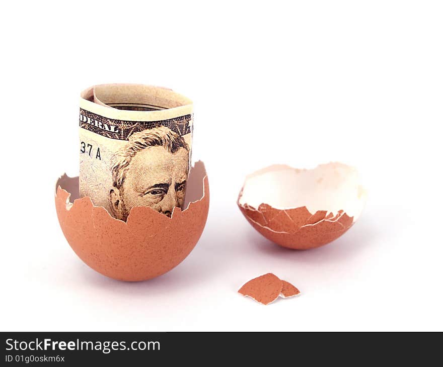 US dollar bank note inside of cracked egg. US dollar bank note inside of cracked egg