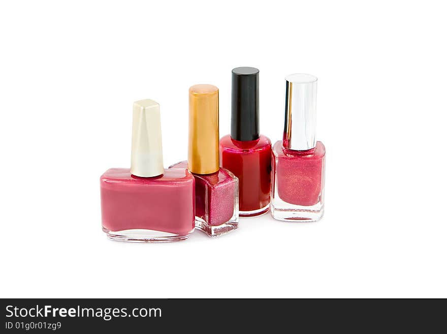 Group of pink and red nail polish on white background