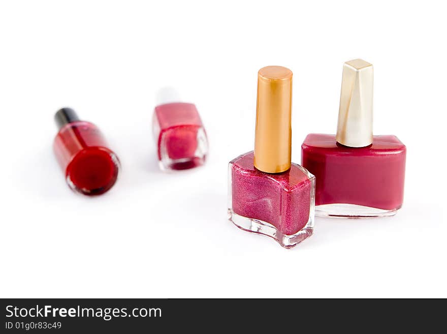 Group of pink and red nail polish on white background