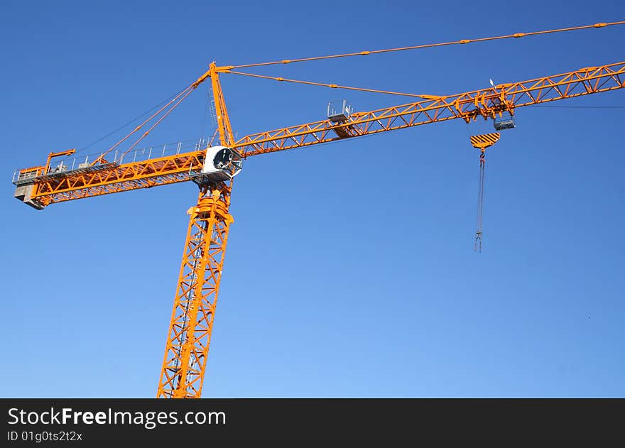 Lifting crane on dark blue