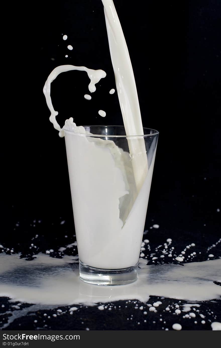 Milk falling down to glass. Milk falling down to glass