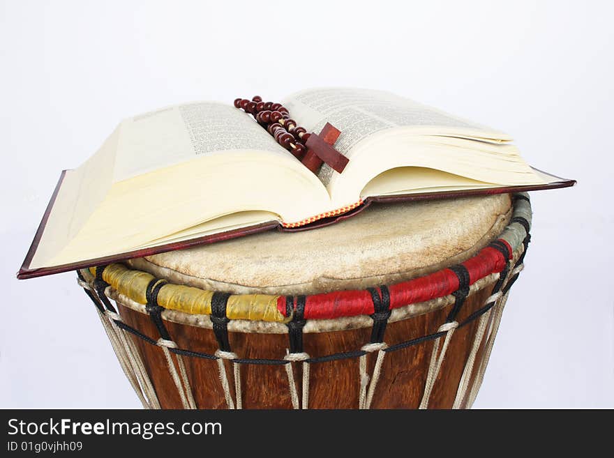 Bible and rosary on drum in white background. Bible and rosary on drum in white background