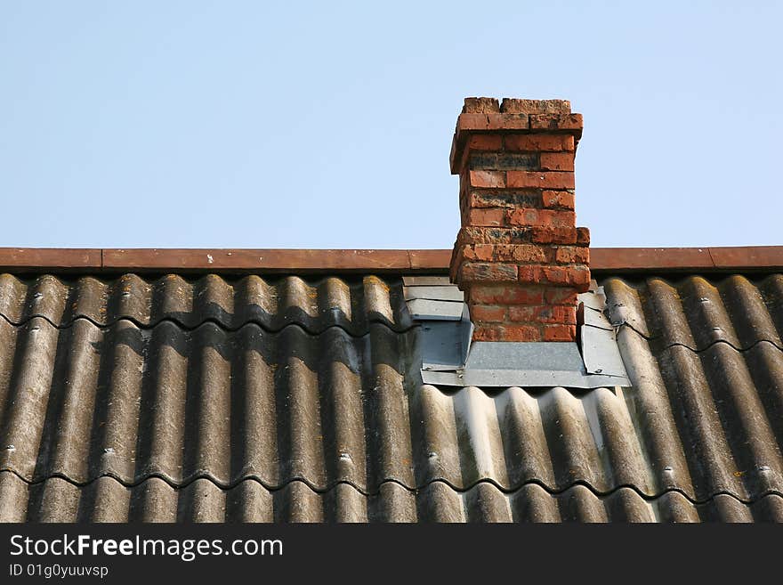 Brick pipe on a roof of the rural house