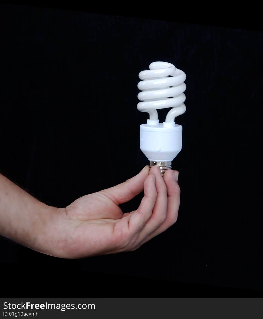 Hand holding an energy-saving lamp. Hand holding an energy-saving lamp