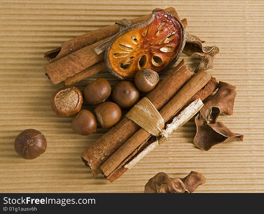 Cinnamon dried orange and hazelnut composition closeup. Cinnamon dried orange and hazelnut composition closeup