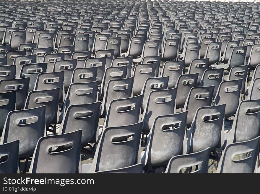 Hundreds of grey chairs in rows at the Vatican, viewed from the back. Hundreds of grey chairs in rows at the Vatican, viewed from the back.