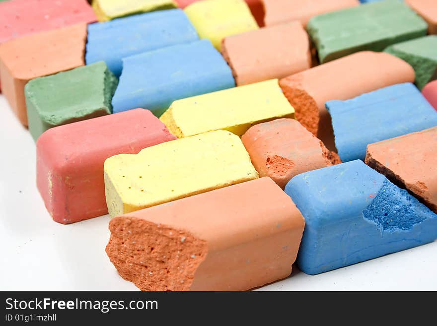 Set of mixed colored crushed childrens chalks, stacked in horizontal rows. Set of mixed colored crushed childrens chalks, stacked in horizontal rows