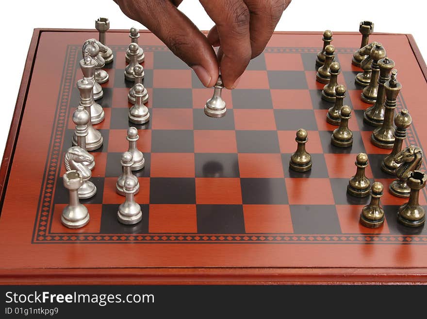 African American male hand on chess board. African American male hand on chess board.