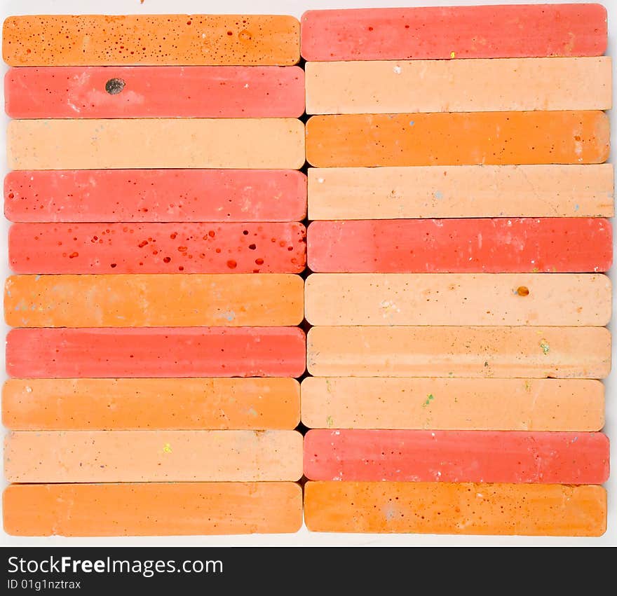 Colored background from two vertical rows of red and orange chalks