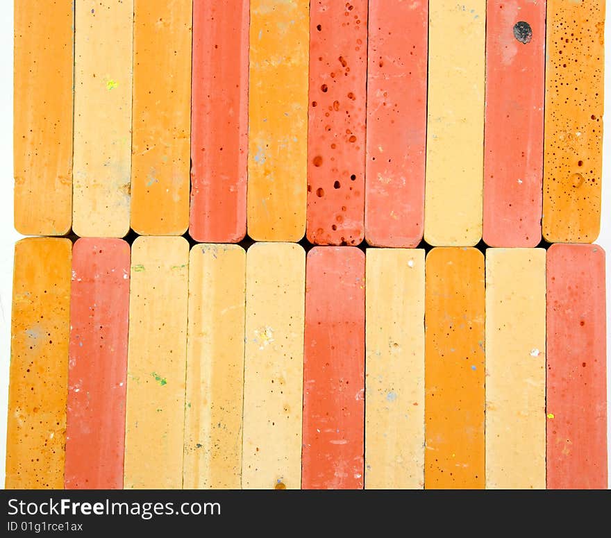 Colored background from two horizontal rows of red and orange chalks