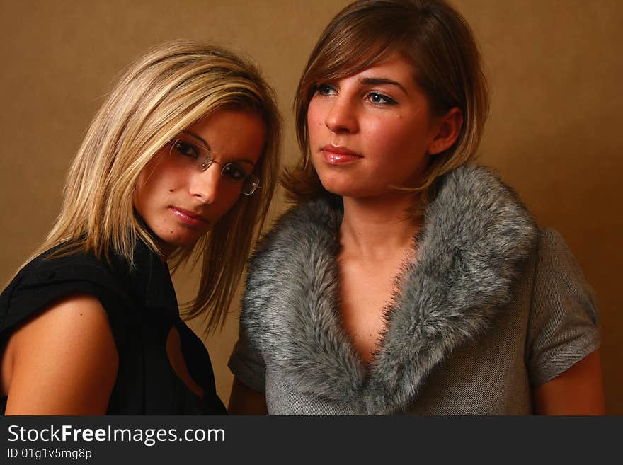 Two women, elegant. best friends in the soft light of a studio. Two women, elegant. best friends in the soft light of a studio