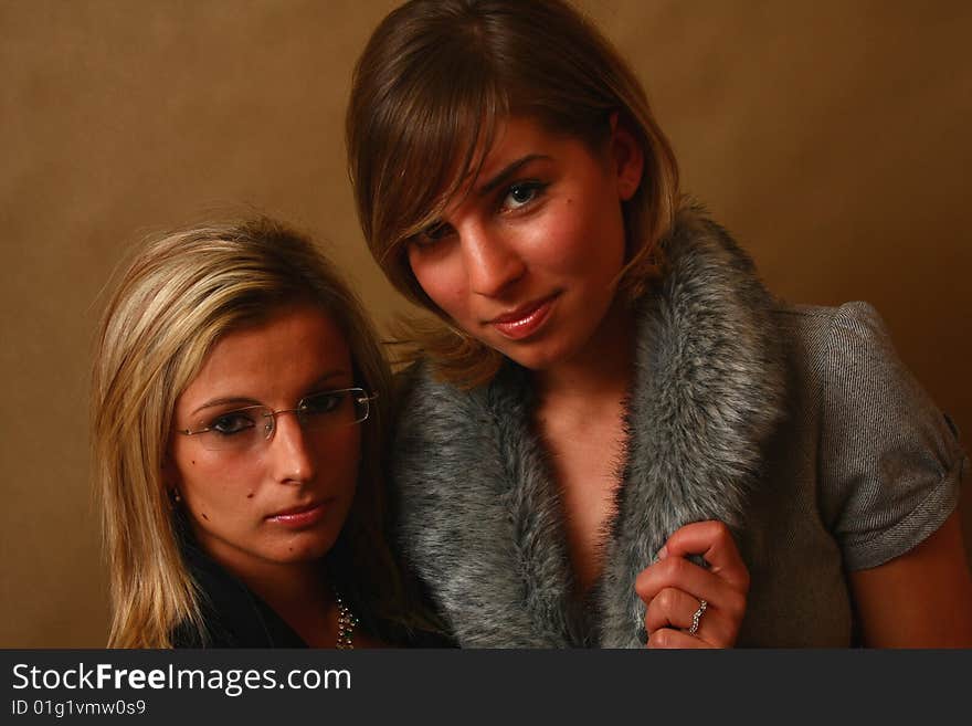 Two women, elegant. best friends in the soft light of a studio. Two women, elegant. best friends in the soft light of a studio