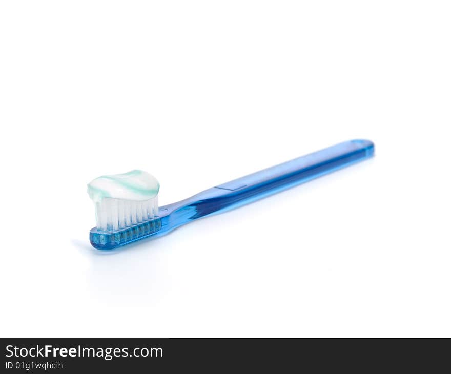 A blue toothbrush full of toothpaste isolated on white background.