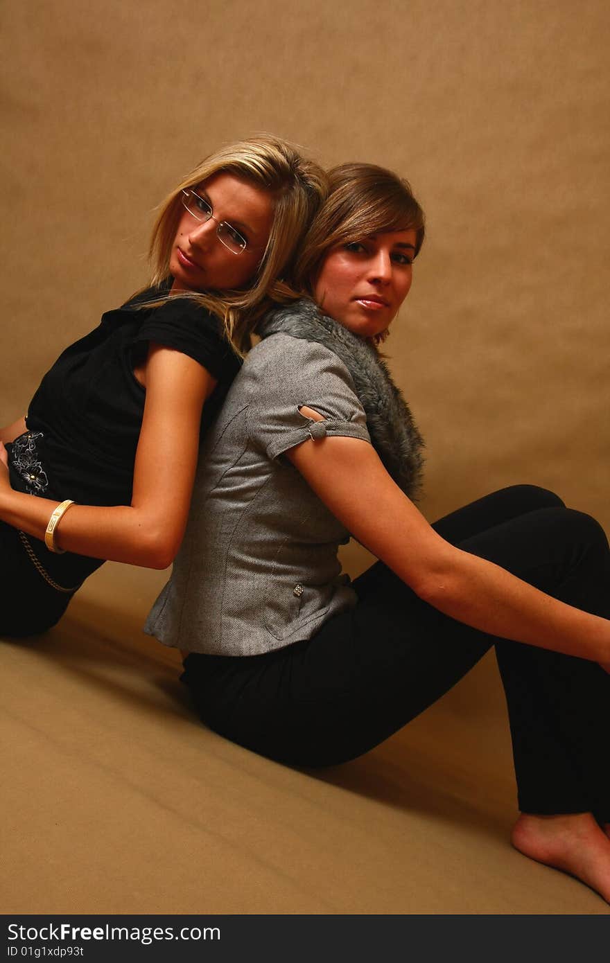 Two women, elegant. best friends in the soft light of a studio. Two women, elegant. best friends in the soft light of a studio