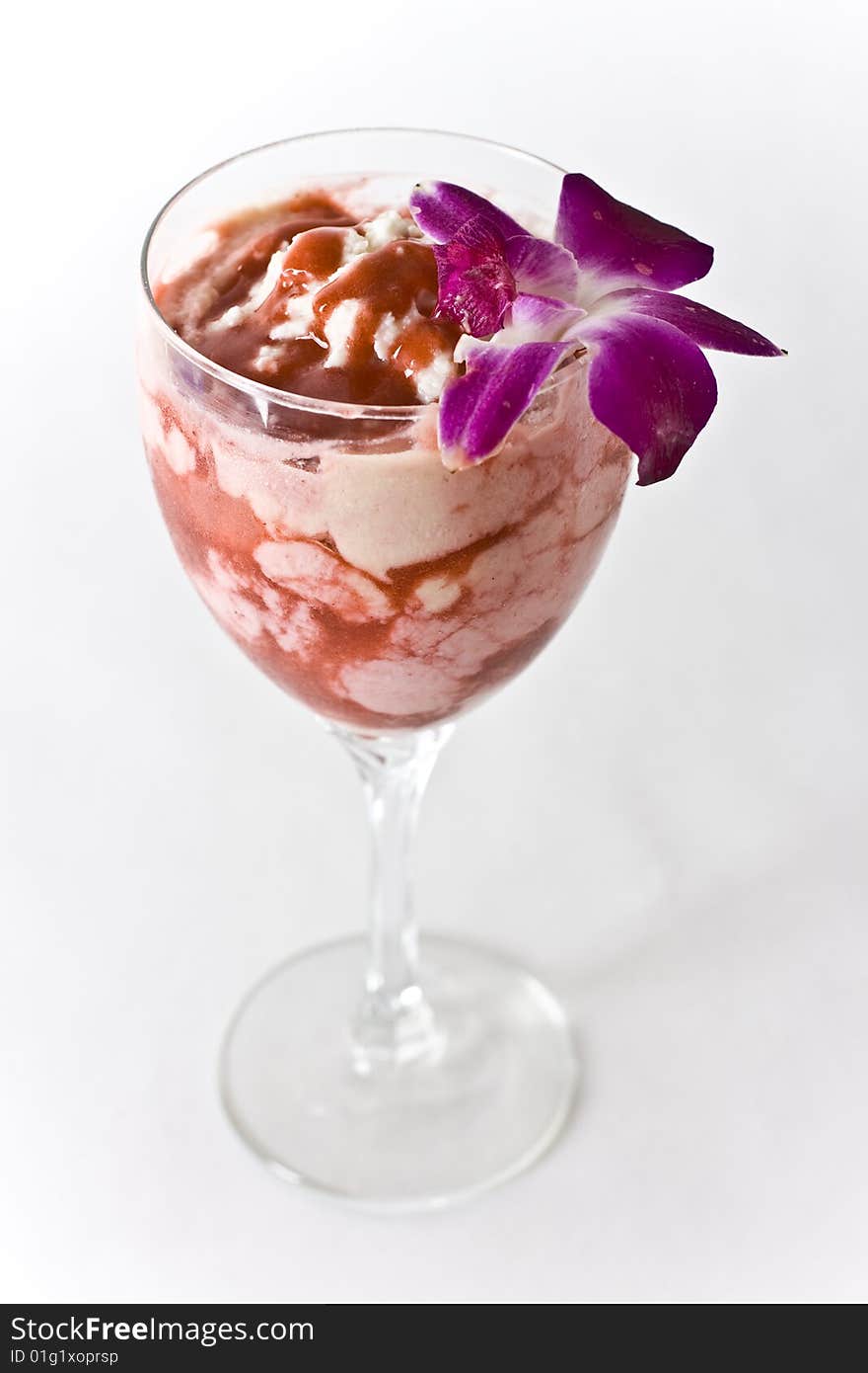 Strawberry Vanilla Parfait on a glass with a flower